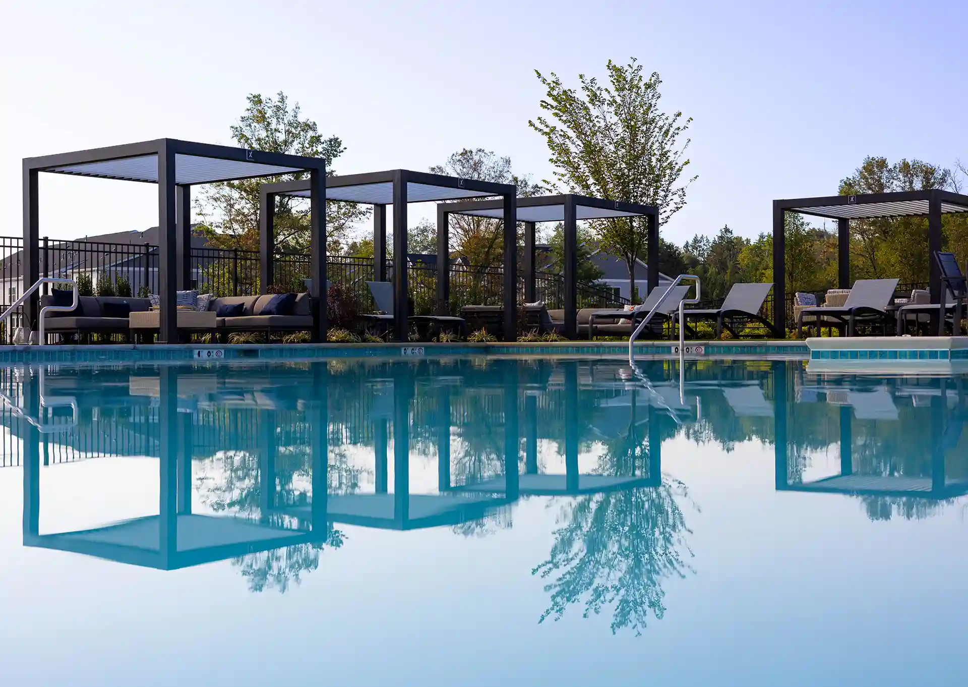 Photo of four StruXure Cabanas along a pool.