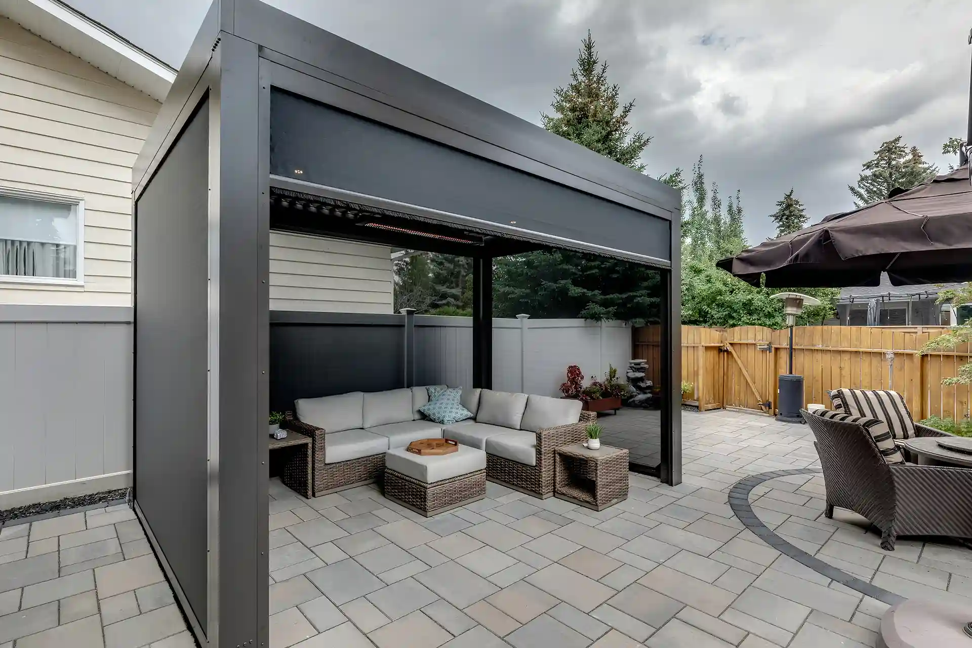 Photo of a StruXure Pergola with custom enhancements, like curtains and heaters.